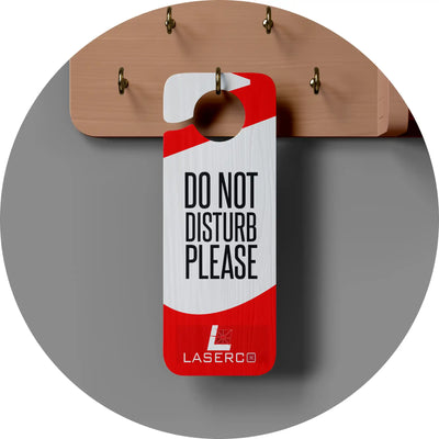 Red and white ’Do Not Disturb Please’ door hanger with Lasero branding.